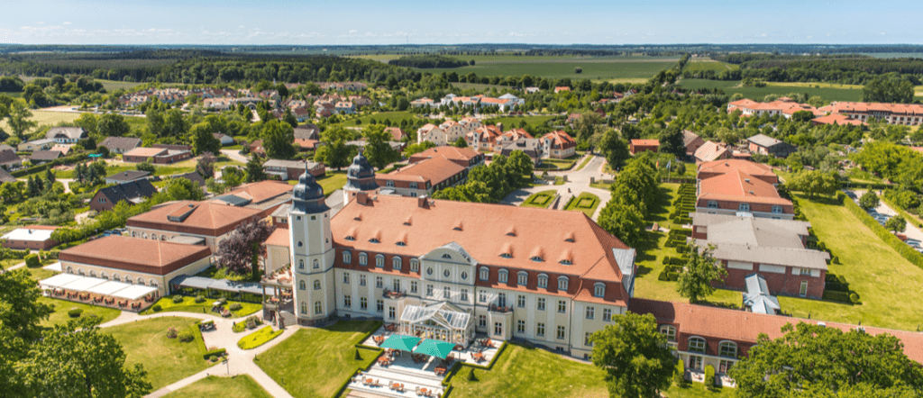 Aerial view of Göhren Rügen Germany showing seaside resort buildings, red rooftops, and surrounding countryside.
