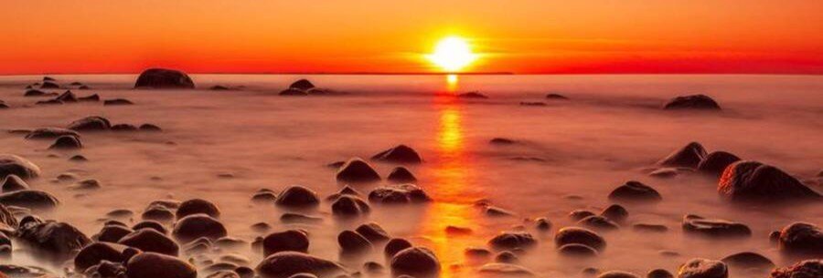 Sunset over the rocky Baltic coastline near Lohme on Rügen Island Germany with calm sea and coastal rocks