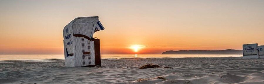 Strandkorb beach basket at sunset on Rügen Island Germany overlooking the Baltic Sea coastline