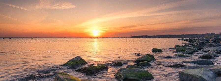 Sunset over the Baltic Sea in Thiessow on Rügen Island with rocky shoreline
