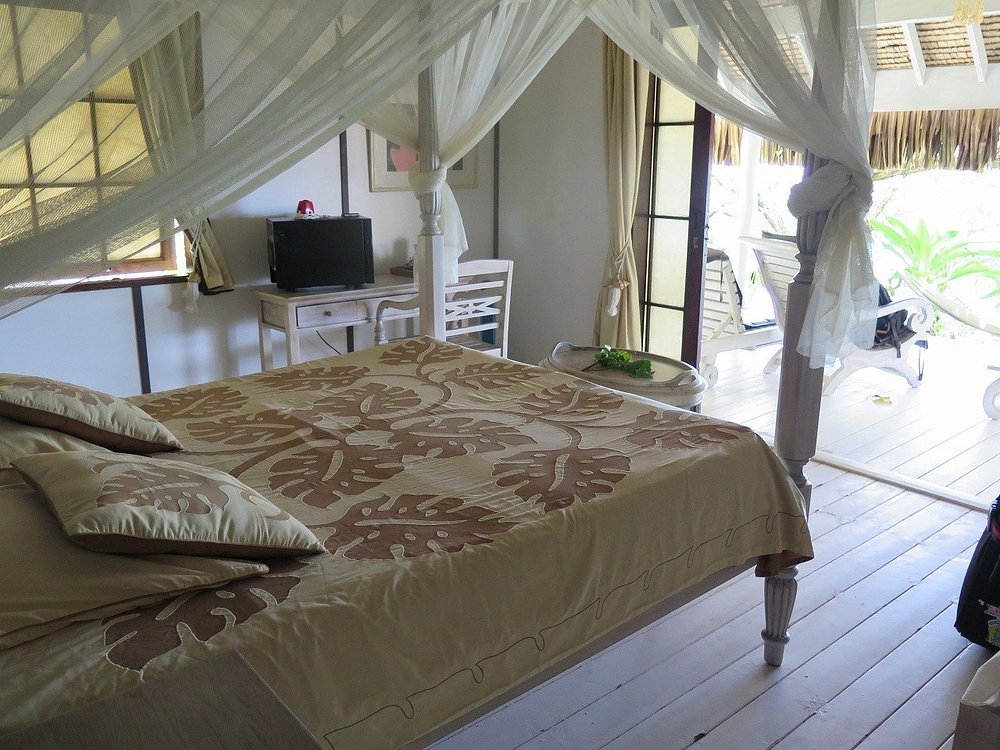 Guest suite with canopy bed at Les Relais de Josephine Rangiroa