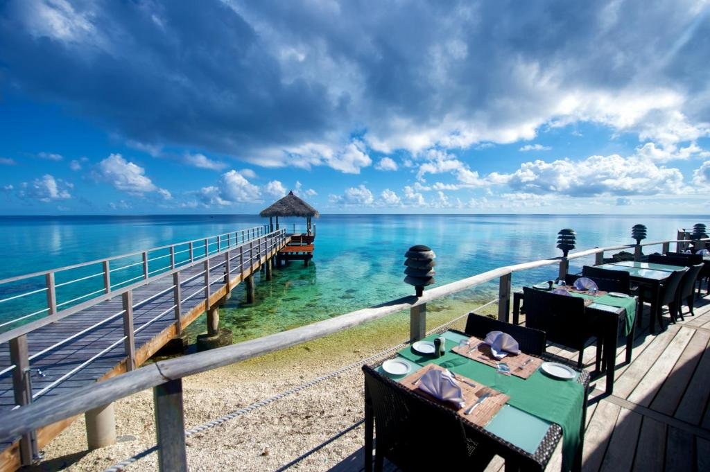 Outdoor dining terrace and lagoon pier at Maitai Rangiroa
