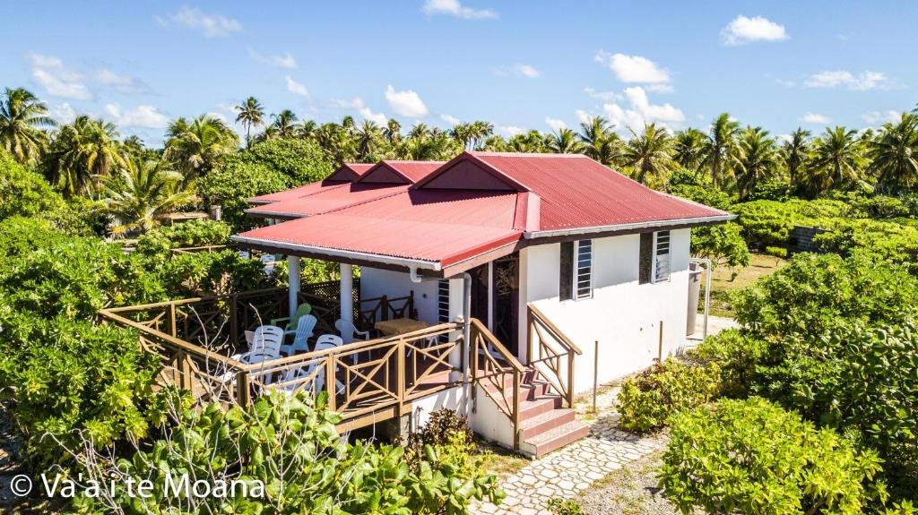Va’a i Te Moana bungalow with red roof, private terrace, and tropical garden setting