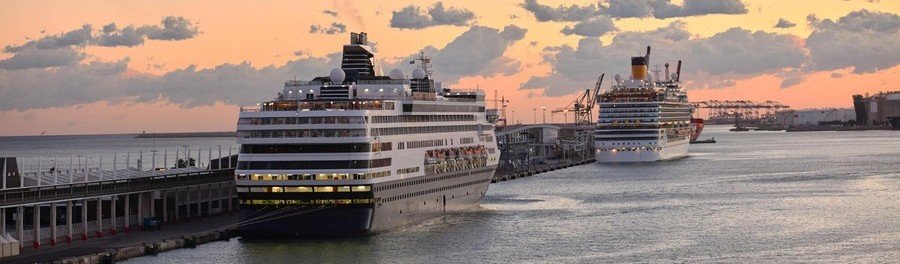 Barcelona cruise port aerial view with ships docked near the city and coastline