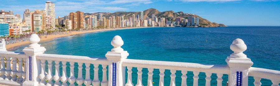 Benidorm skyline overlooking a wide sandy beach and turquoise Mediterranean Sea on the Costa Blanca in SpainBenidorm skyline overlooking a wide sandy beach and turquoise Mediterranean Sea on the Costa Blanca in Spain