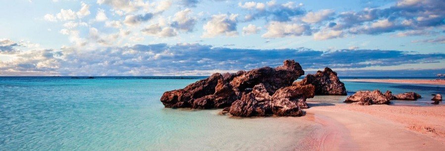 Pink sand beach with turquoise lagoon and rock formations in Fakarava French Polynesia