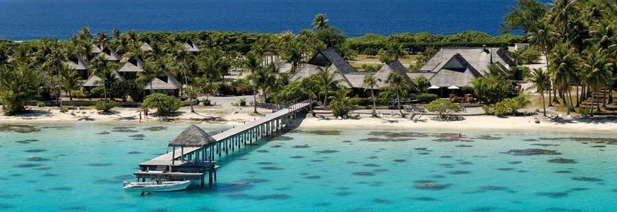 Beachfront resort with overwater pier and turquoise lagoon in Fakarava French Polynesia