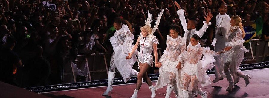 Lady Gaga performing on stage at Copacabana Beach in Rio de Janeiro Brazil during a large beachfront concert.