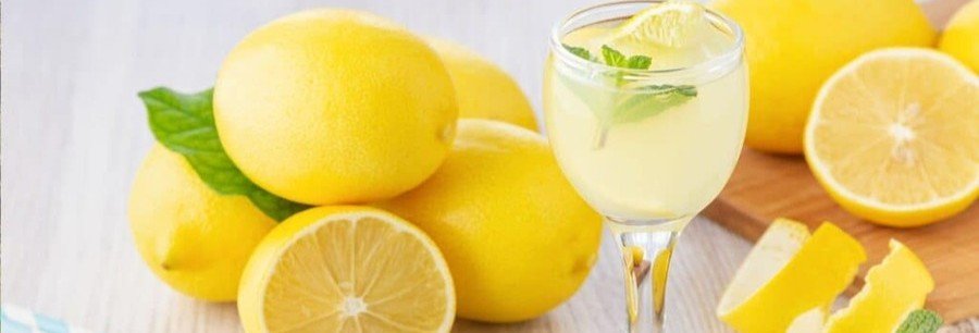 Glass of limoncello with fresh lemons on the Amalfi Coast near Naples Italy