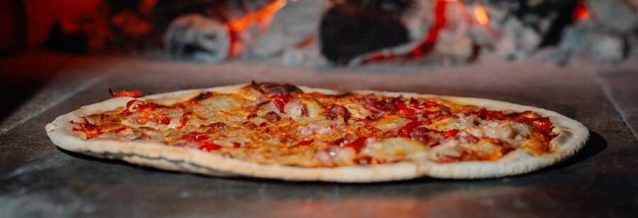 Traditional Neapolitan pizza cooking in a wood fired oven in Naples Italy