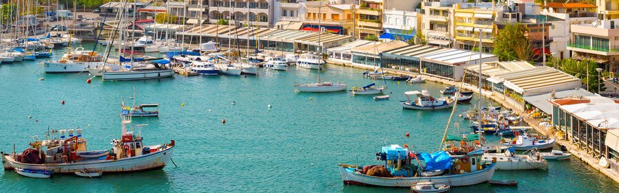 Piraeus port in Athens with marina boats and waterfront buildings in Greece