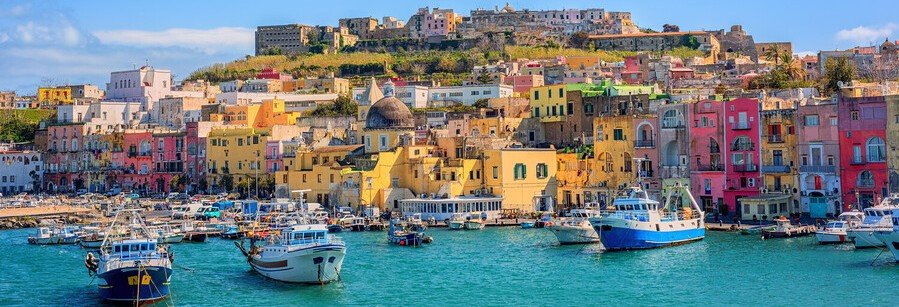 Colorful houses and fishing boats in the harbor of Procida Island near Naples Italy
