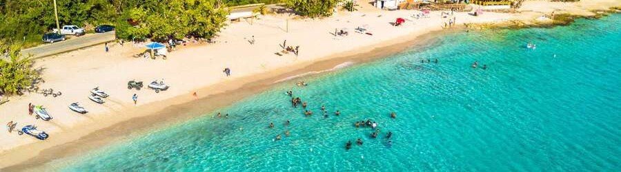 Aerial view of beach with clear turquoise water and swimmers in St Croix US Virgin Islands