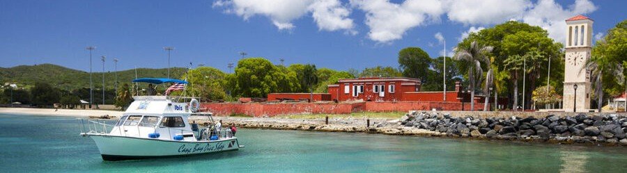 Boat near Frederiksted harbor with Fort Frederik in background St Croix US Virgin Islands