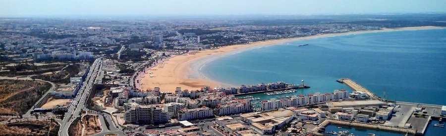 Aerial view of Agadir cruise port, city, and sweeping beach in Morocco.