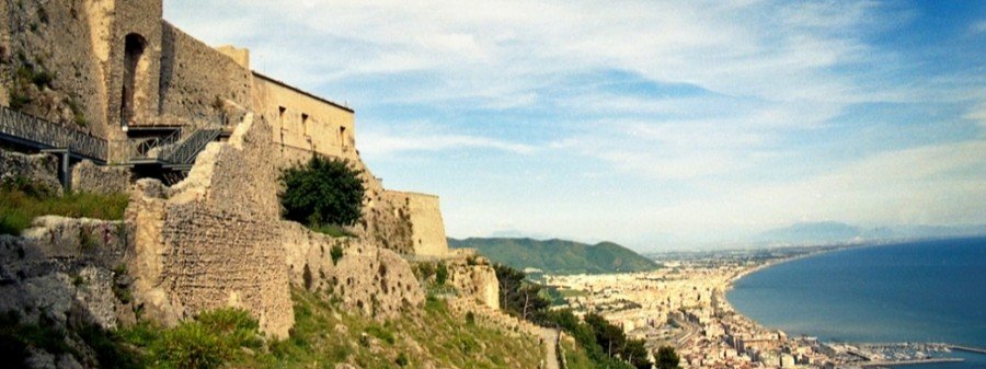 Sweeping aerial view of Salerno’s terracotta rooftops and blue Gulf from the stone walls of Arechi Castle.