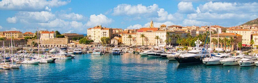 Boats and marina at Bastia Port with waterfront buildings in Corsica France