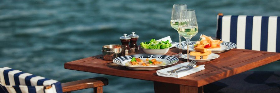 Elegant beachside dining table with seafood, wine, and ocean view on the French Riviera in Cannes