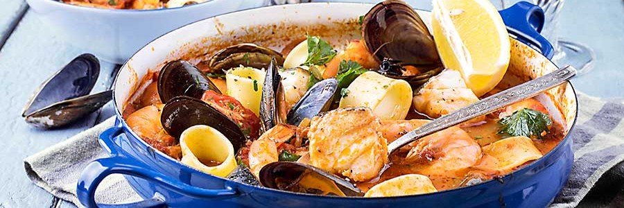 Traditional bouillabaisse fish stew from Marseille with seafood, broth, and lemon