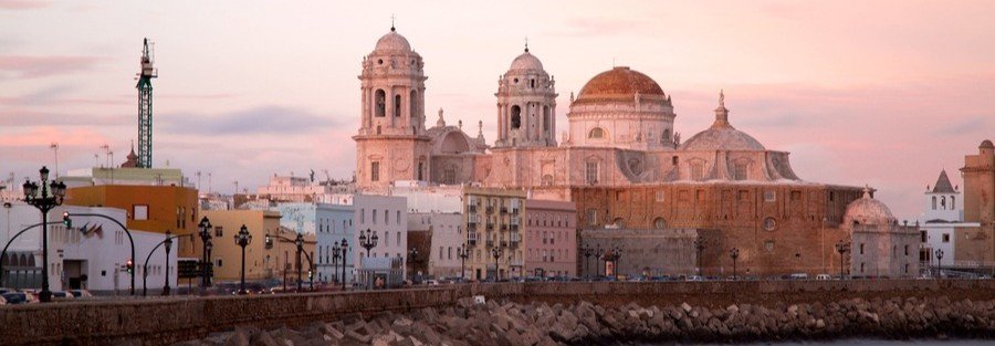 Cádiz Cathedral with golden dome at sunset viewed from the waterfront near the cruise port