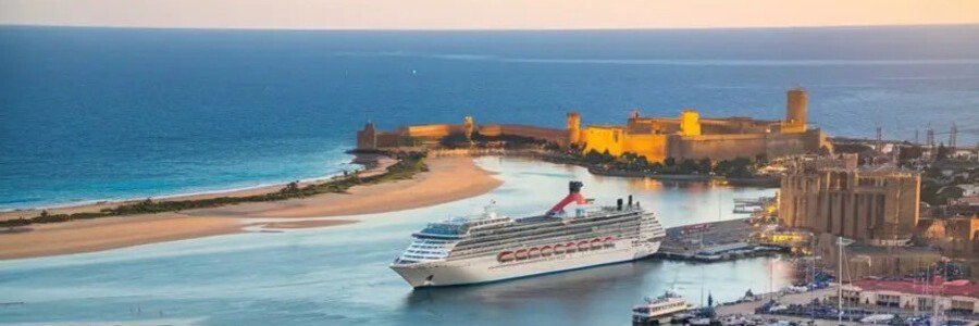 Cruise ship docked at Cagliari port with historic harbor and coastline in Sardinia Italy