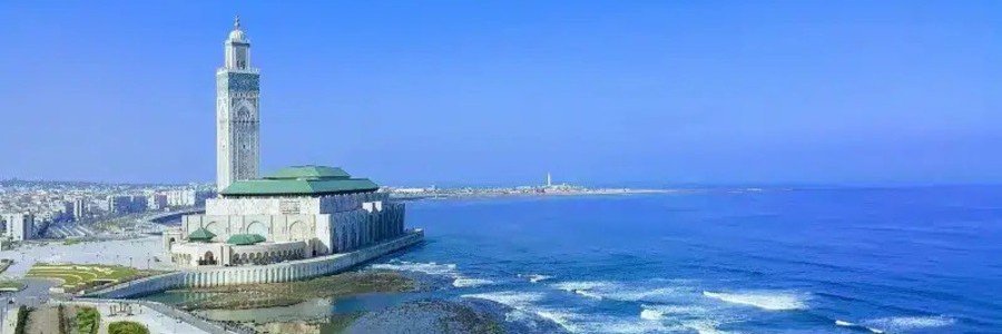 Panoramic view of Casablanca Port and Hassan II Mosque overlooking the Atlantic Ocean in Morocco.