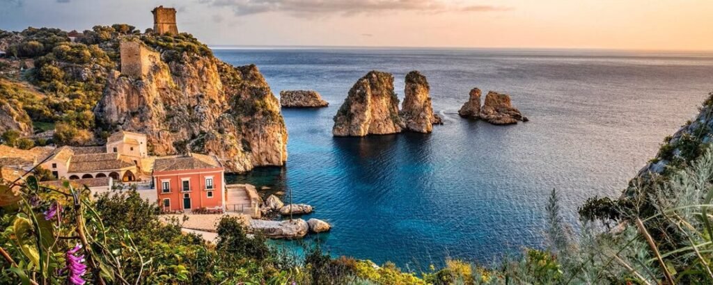Catania Port Sicily coastal cliffs with clear blue water and dramatic rock formations along the coast