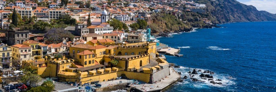 The bright yellow Fort of São Tiago on the Funchal waterfront in Madeira, overlooking the Atlantic Ocean near Funchal Port.