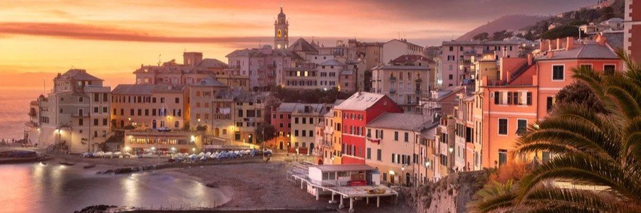 Sunset over Genoa harbor with colorful buildings and calm sea