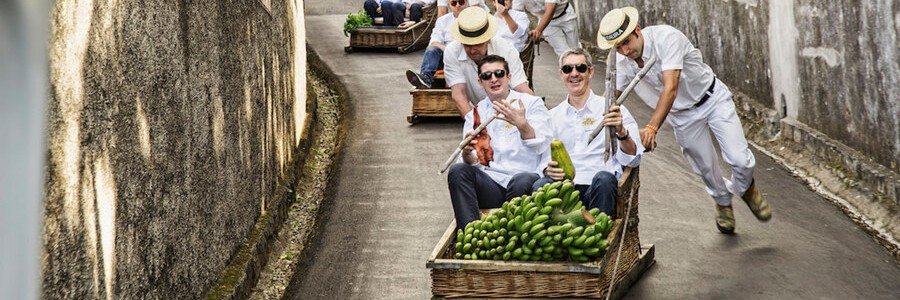 Traditional Monte toboggan ride in Madeira with wicker sled and guides