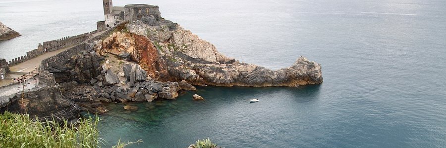 Rocky coastline at Grotta di Byron near Porto Venere with clear blue water