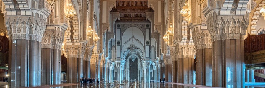 Interior arches and grand prayer hall of Hassan II Mosque during a perfect day in Casablanca.