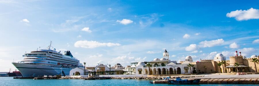 Cruise ship docked at La Goulette Port in Tunisia near the historic waterfront.