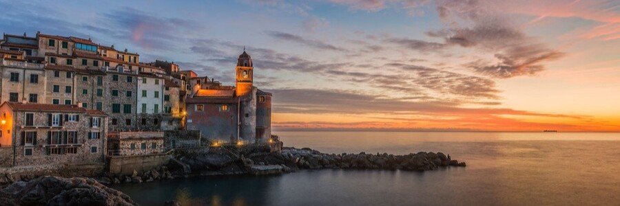 Sunset over La Spezia coastline with warm colors reflecting on the sea