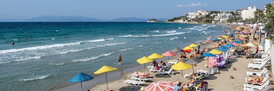 Ladies Beach Kusadasi with colorful umbrellas and clear water