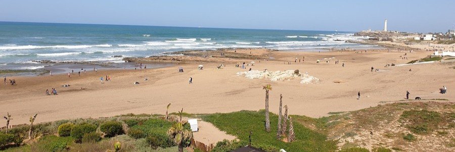 Sandy shoreline at Lalla Meryem Beach near Casablanca Port with Atlantic waves and coastal views.