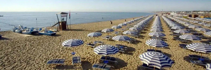 Rows of umbrellas and loungers at Lido Azzurro beach club in Catania