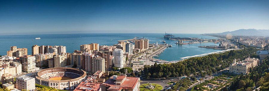 Málaga city view with port, coastline, bullring, and Mediterranean Sea