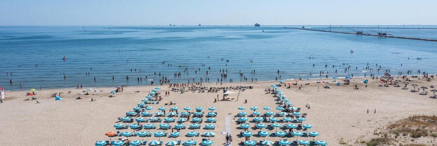 Marina Romea Beach near Ravenna with umbrellas and calm Adriatic waters
