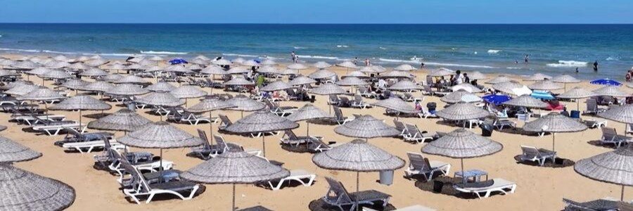 Marmara Sea beach near Istanbul with sunbeds and umbrellas along sandy shore