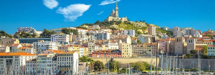 Vieux Port Marseille with boats and Notre-Dame de la Garde on the hill above the city