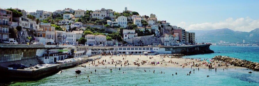 Marseille beach near the port with coastal town and clear Mediterranean water