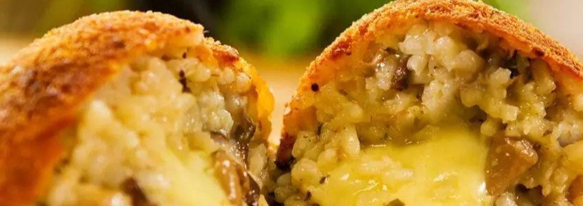 Sicilian arancini rice balls with melted cheese filling