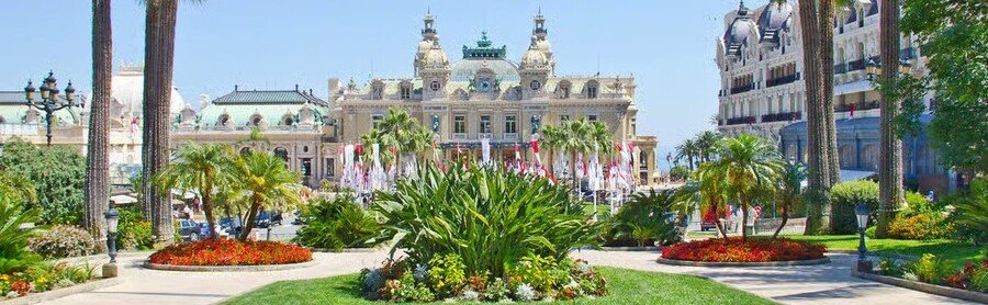 Monte Carlo Casino Monaco with gardens and palm trees in Casino Square