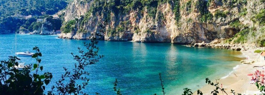 Nice Port and Nice Cruise Port near Plage de la Réserve beach with turquoise water and rocky cliffs along the French Riviera