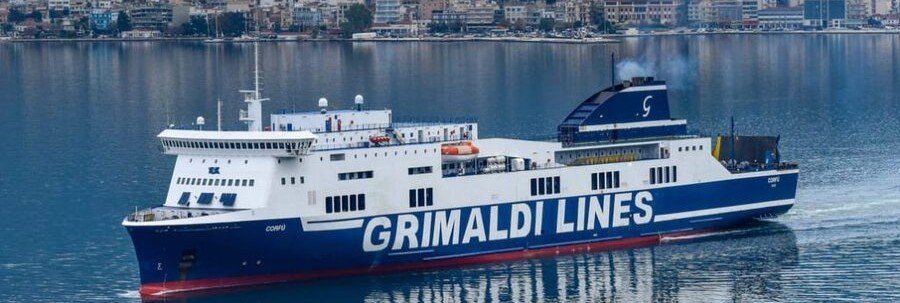 Cruise ship docked at Palermo port with city waterfront in the background