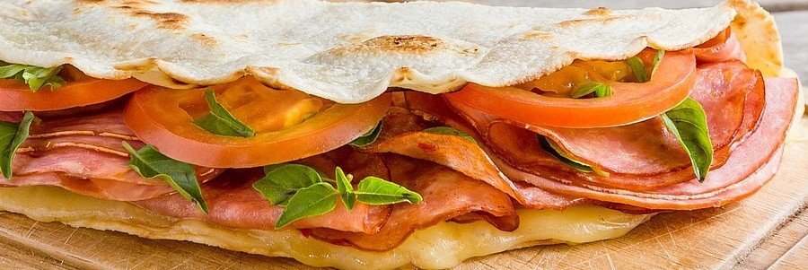 Traditional piadina sandwich with cured meat and cheese in Ravenna Italy
