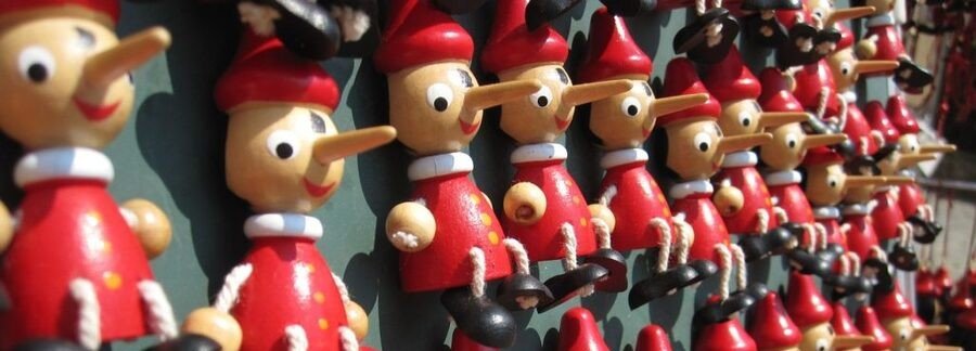 Colorful Pinocchio figurines displayed in a Florence souvenir shop