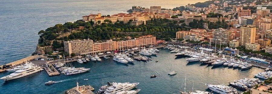 Port Hercule Monaco with luxury yachts and Monaco Ville on the hill above the harbor