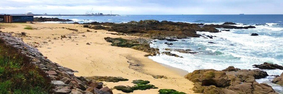 quiet Praia de Fuzelhas beach with rocky shoreline near Porto Portugal
